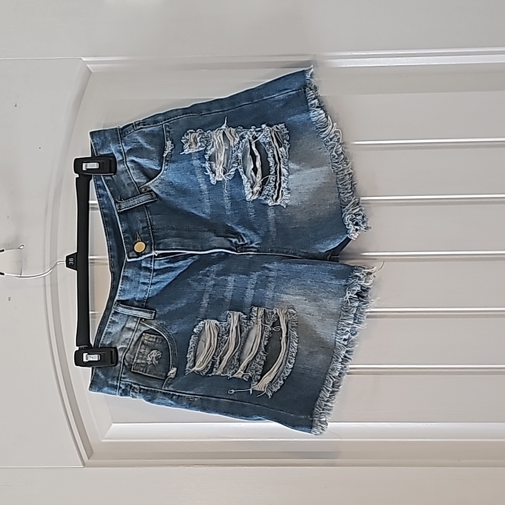 Size medium denim shorts with ripps in the front